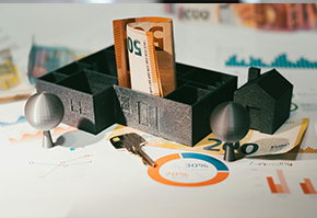 Model house with money and charts